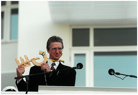 Man holding up a model of the JTH and JIBS building at the  inauguration of the buildings