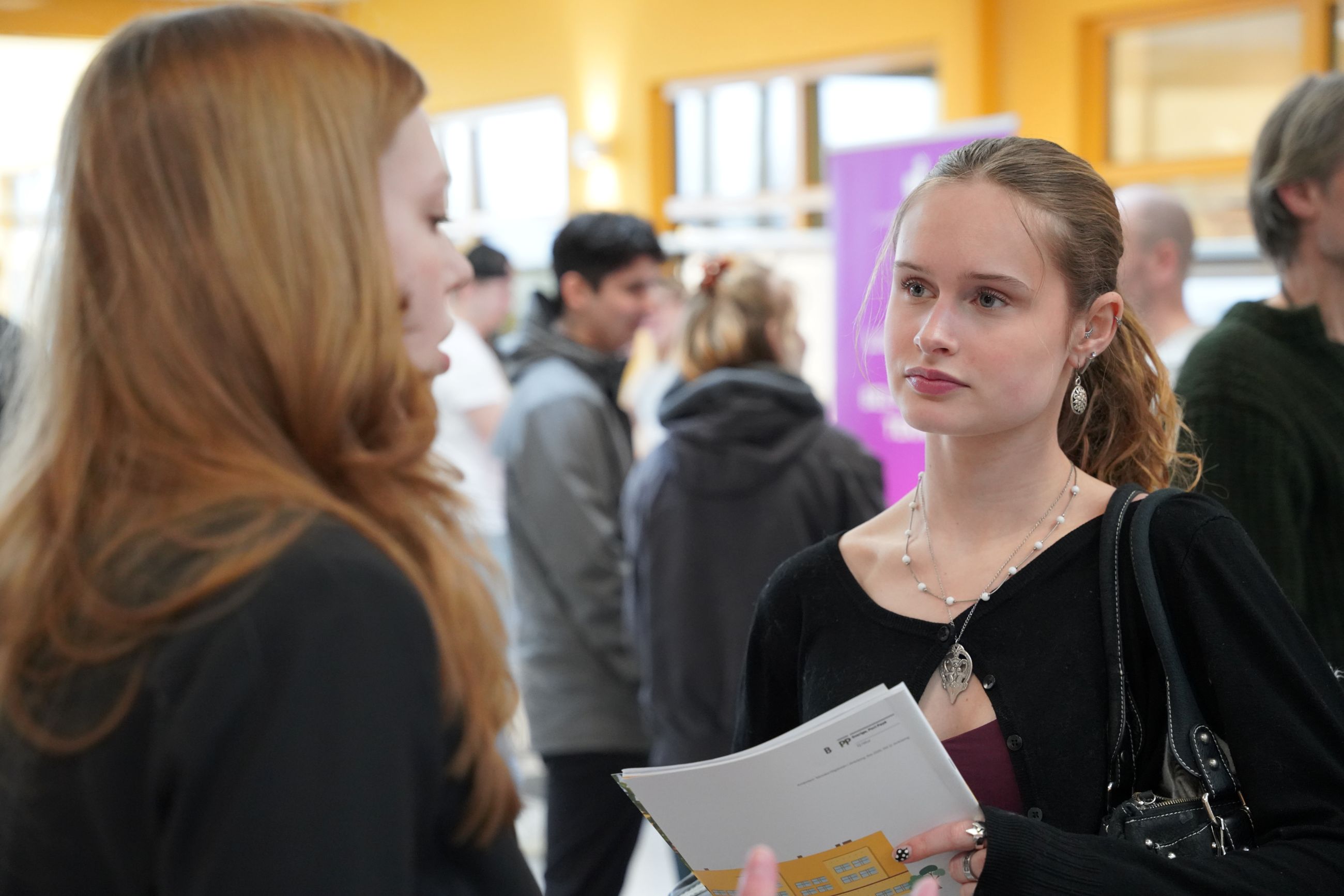 young girl speaking to another girl. 