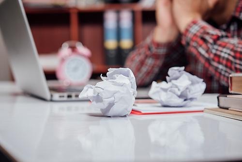 paper ball and laptop